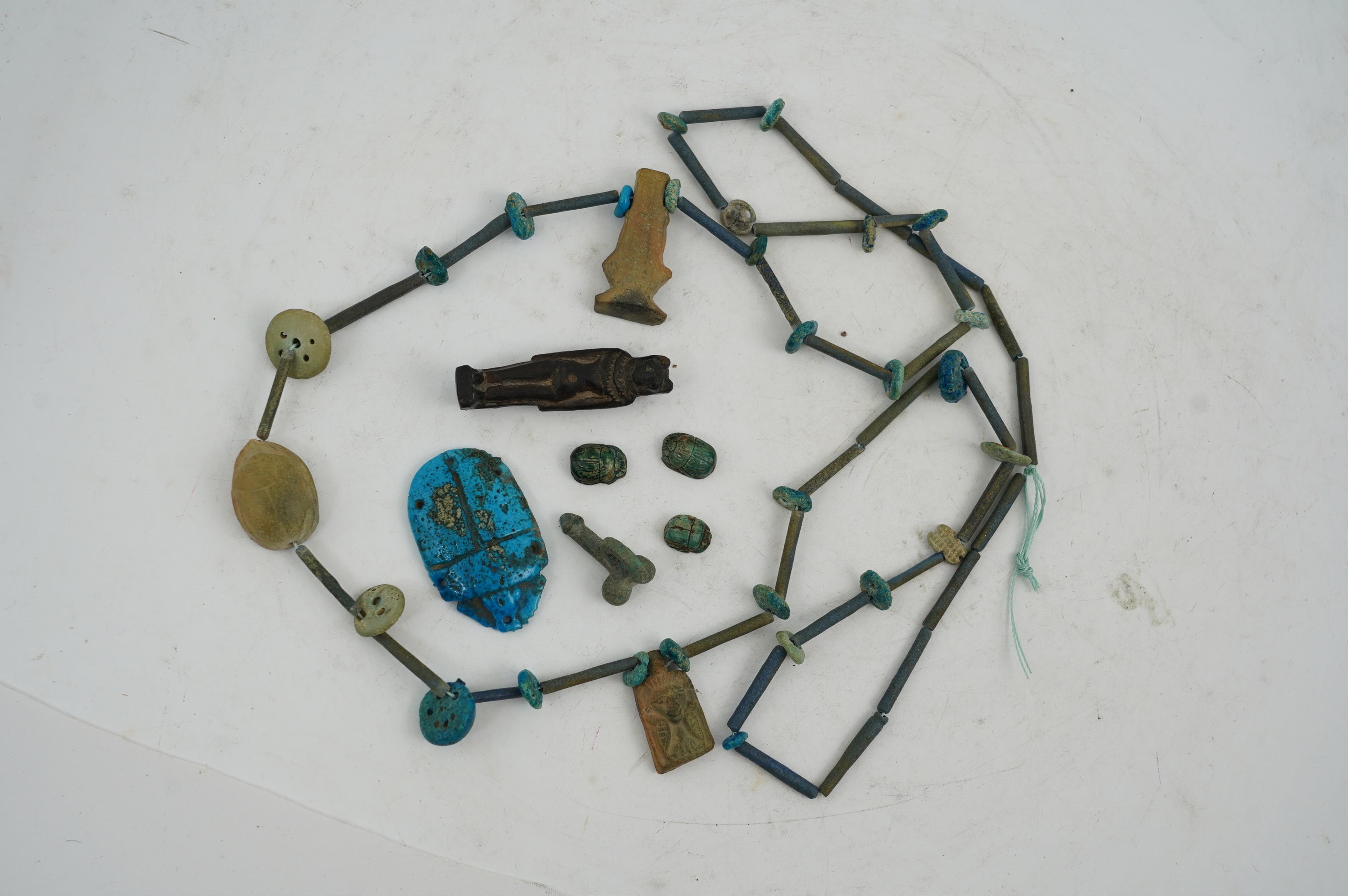 An ancient Egyptian faience necklace, amulets and scarabs, late Kingdom to Ptolemaic period